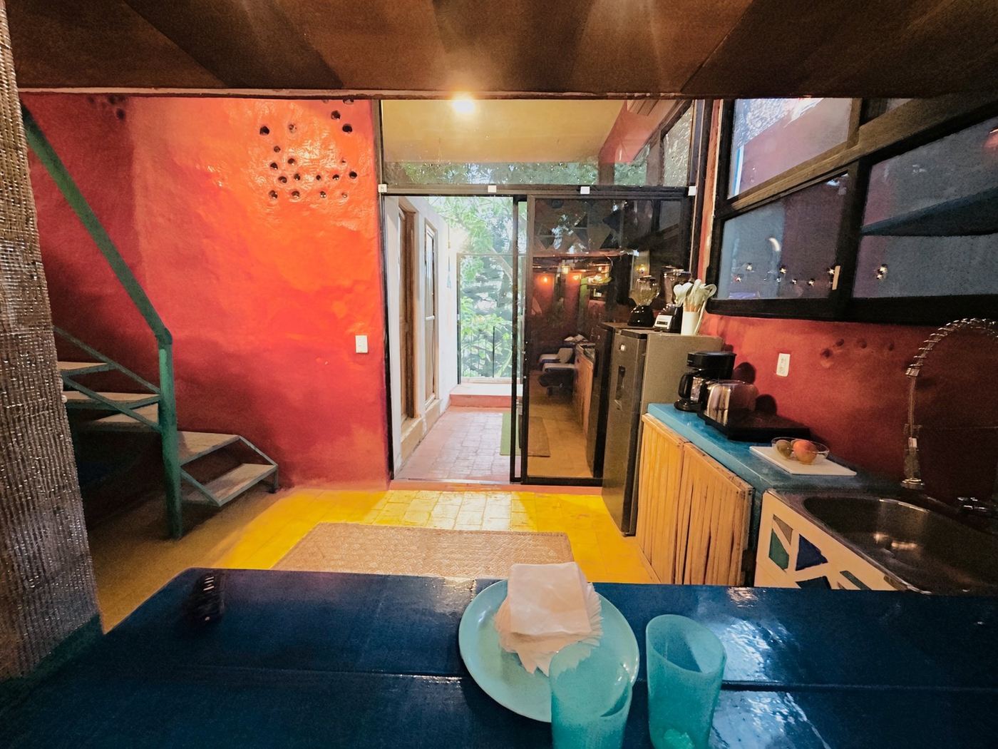 Looking out from El Loft to the trees beyond the glass door