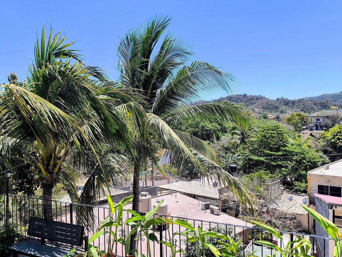 The balcony at Casita Sol, palms and the mountain above Sayulita